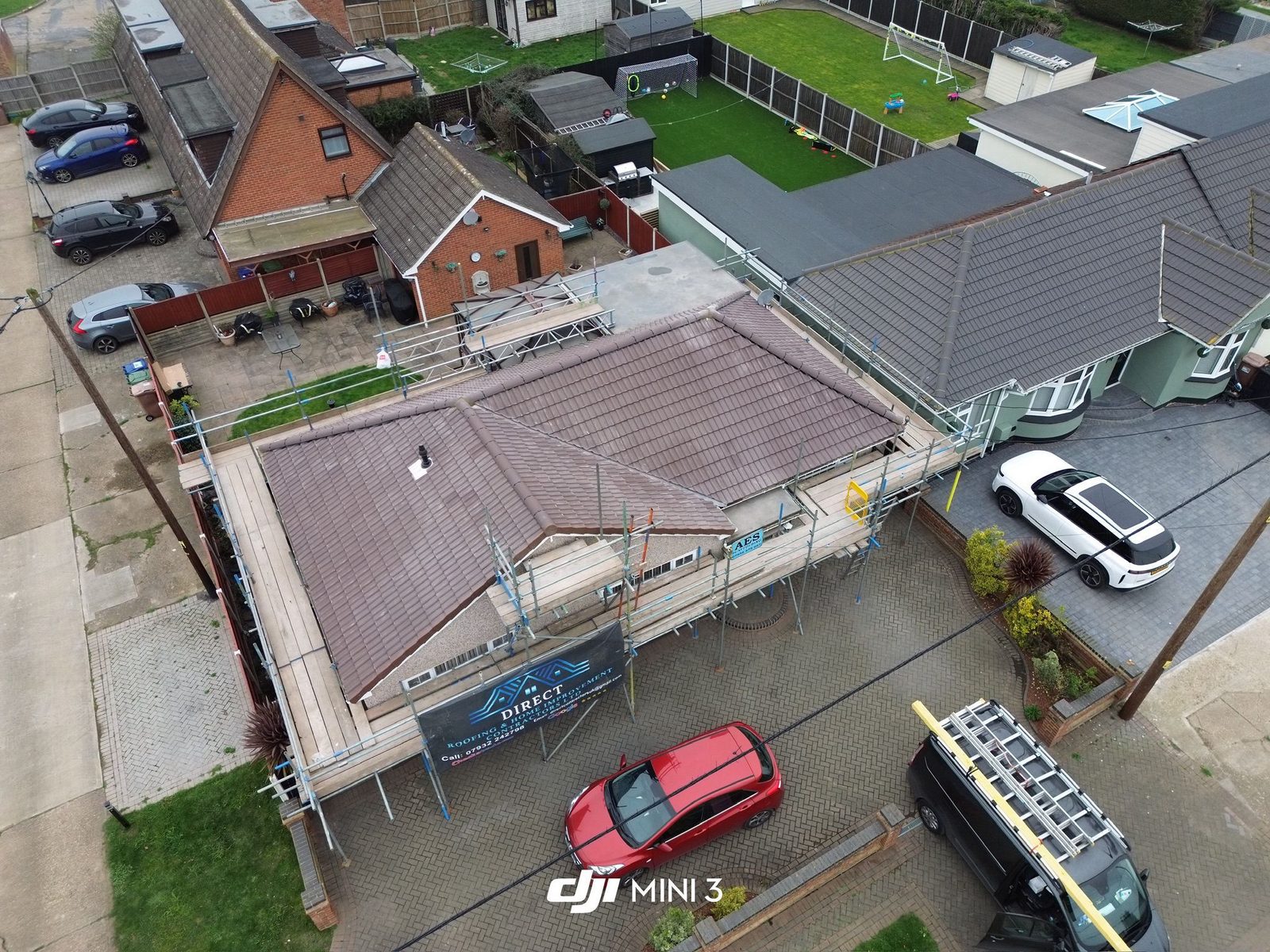 Elevated view of a new grey tiled roof above a residential street