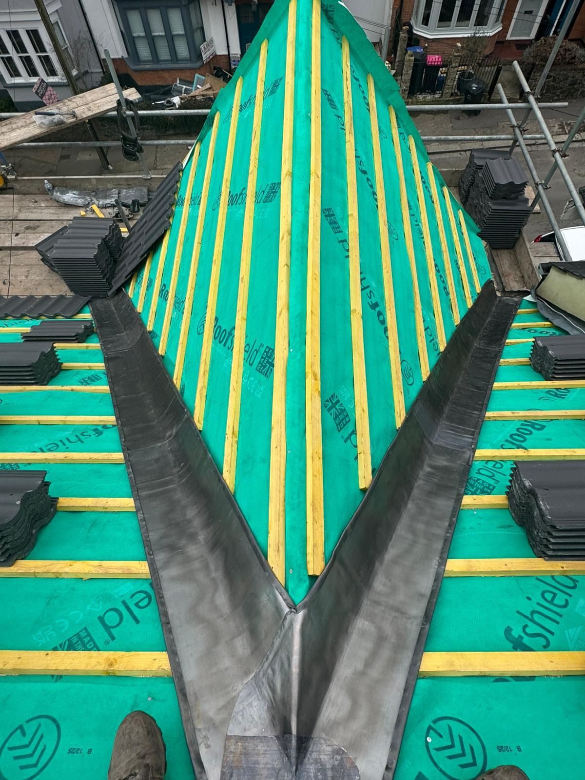 New roofing membrane and battens installed across a stripped roof