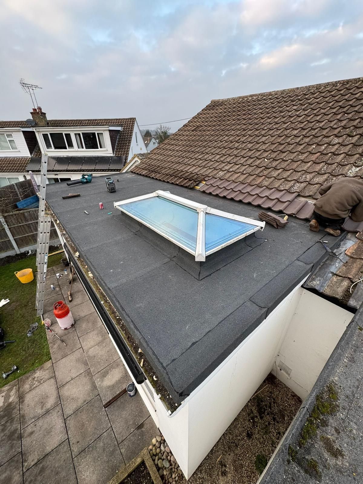 Grey tiled roof with new skylight windows