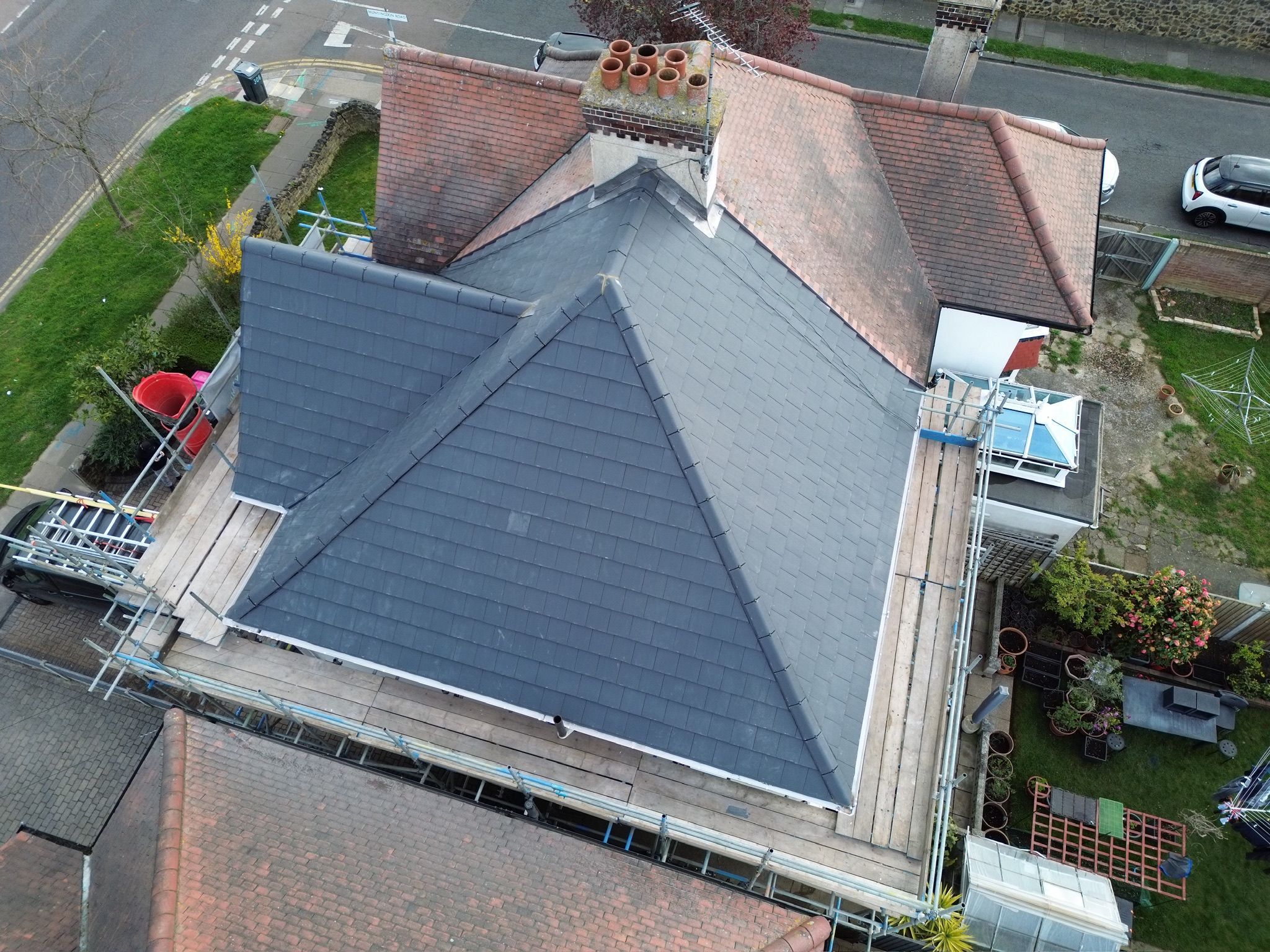 Clean grey slate roof with red clay ridge tiles