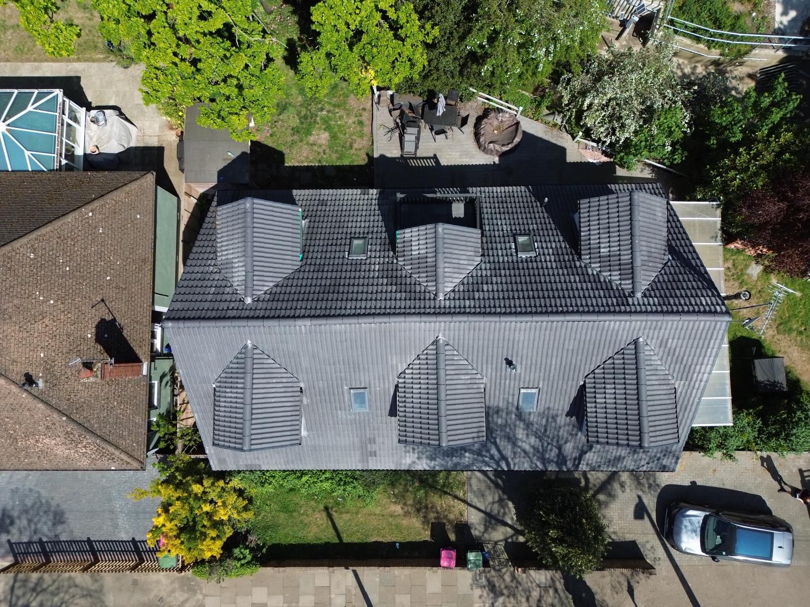 Large grey tiled roof with dormer windows