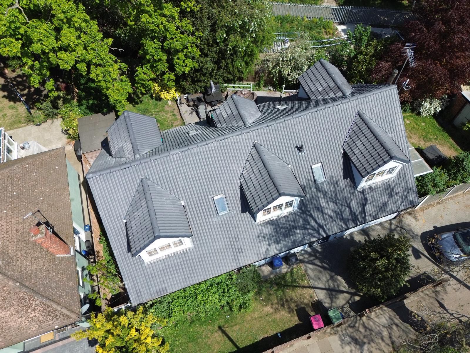 Newly finished grey tiled roof with dormer windows completed to a high standard